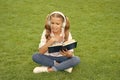 teen girl lifestyle. tween dislike the book. relax in park. music education while listening. lifestyle of teenager girl Royalty Free Stock Photo