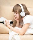 Teen girl listening music with the headphones Royalty Free Stock Photo