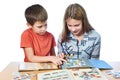 Teen girl and little boy with magnifier looking his stamp collection isolated Royalty Free Stock Photo