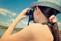 Teen girl looking through binoculars closeup toning