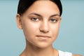 Teenage girl looking at camera, close up. Portrait of girl slight smile and calm expression on face