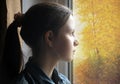 Teen girl looking out the window