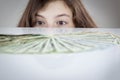 Teen girl looking at US dollars Royalty Free Stock Photo