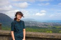 Teen girl looking at view of Oahu from Pali Lookout