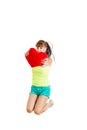 Teen girl in love jumping of joy holding red heart Royalty Free Stock Photo