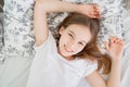 Teen girl lying in bed idle in quarantine.