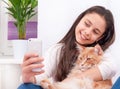 Girl makes selfie with a cat. Royalty Free Stock Photo