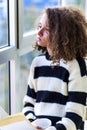 Teen girl with mug by window Royalty Free Stock Photo