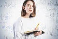 Teen girl with notebook and formula, education