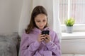 Teen girl obsessed with smartphone social media apps at home