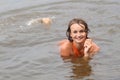 Teen girl in orange dress dabbles in water Royalty Free Stock Photo