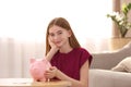 Teen girl with piggy bank and money Royalty Free Stock Photo