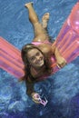 Teen girl in pink bikini on a float