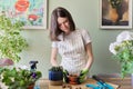 Teen girl plants small cactus in pot. Hobbies and leisure, home gardening, houseplant Royalty Free Stock Photo