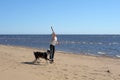 Teen girl playing with a dog in the sand Royalty Free Stock Photo