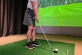 Teen girl playing in a golf simulator indoors Royalty Free Stock Photo