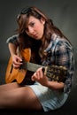 Teen girl playing guitar Royalty Free Stock Photo