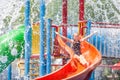 Teen girl playing in the swimming pool on slide Royalty Free Stock Photo