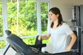 Teen girl with pony tail jogging on treadmill Royalty Free Stock Photo