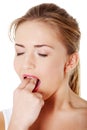 Teen girl putting her finger in her mouth Royalty Free Stock Photo