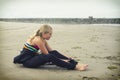 Teen girl putting on a wetsuit at Rockaway Oregon Royalty Free Stock Photo