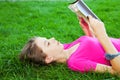 Teen girl reading the Bible outdoors Royalty Free Stock Photo