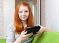 Teen girl reads e-reader or tablet computer Royalty Free Stock Photo