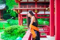 Teen girl at a red Japanese or Chinese Bhuddist temple Royalty Free Stock Photo