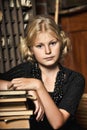 Teen girl in retro style with a stack of books Royalty Free Stock Photo