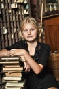 Teen girl in retro style with a stack of books Royalty Free Stock Photo