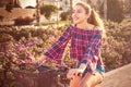 Teen girl riding bicycle in a city flowers park