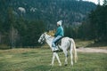 Teen girl riding a horse on meadow Royalty Free Stock Photo