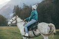 Teen girl riding a horse on meadow Royalty Free Stock Photo