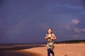 Teen girl runs along the beach