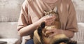 Teen girl with sad abyssinian cat on knees sitting on couch Royalty Free Stock Photo