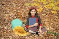 teen girl in school uniform hold autumn leaves. happy child with maple leaf bunch and backpack Royalty Free Stock Photo