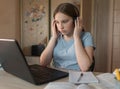 Teen girl, serious thoughtful, attentive concentrated, home lessons with laptop, video training on Internet. Watching in Royalty Free Stock Photo