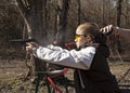 Teen girl shooting pistol with coach's hand timing Royalty Free Stock Photo