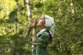 Teen girl shouting, yelling, screaming for help in the green dense forest in summer time