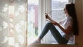 Teen Girl Sits window sill And Works On notebooke