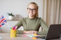 Teen girl sitting at desk with laptop, studying from home Royalty Free Stock Photo