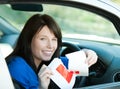 Teen girl sitting in her car tearing a L-sign Royalty Free Stock Photo