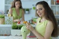 Teen girl sitting at white table and drinking tea Royalty Free Stock Photo