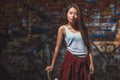 Teen girl with skate board, urban lifestyle. Royalty Free Stock Photo