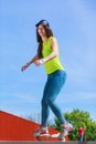 Teen girl skater riding skateboard on street. Royalty Free Stock Photo