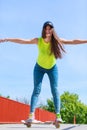 Teen girl skater riding skateboard on street. Royalty Free Stock Photo