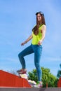 Teen girl skater riding skateboard on street. Royalty Free Stock Photo