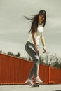 Teen girl skater riding skateboard on street. Royalty Free Stock Photo