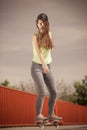 Teen girl skater riding skateboard on street. Royalty Free Stock Photo