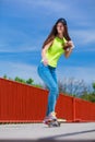 Teen girl skater riding skateboard on street. Royalty Free Stock Photo